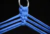 A close-up view of the top of a blue hammock or hanging chair, showing the knotting and the metal ring it attaches to. Anteprima dell’immagine prodotto