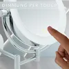 A finger is touching a lighted makeup mirror, indicating a touch dimmer function. Produktbild-Vorschau