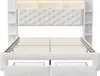 A white upholstered bed frame with a tufted headboard and built-in shelving and storage. Produktbild-Vorschau