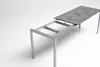 A table with an extendable frame and a tabletop partially extended. Produktbild-Vorschau