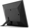 The back of a black digital photo frame is shown, propped up by its stand. Podgląd zdjęcia produktu