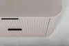 A close-up, top-down view of a beige matte bathroom cabinet with two drawers. Anteprima dell’immagine prodotto