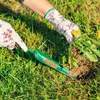 Hands wearing gardening gloves are shown weeding a lawn with a green garden tool. Podgląd zdjęcia produktu