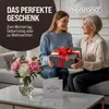 A younger woman gives a gift to an older woman, both smiling. Náhled obrázku produktu