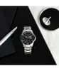 A watch and a spinning top are displayed on a reflective black surface with a white and gray marbled background. Anteprima dell’immagine prodotto