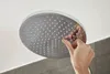 A hand is touching a shower head. Anteprima dell’immagine prodotto