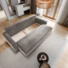 A modern living room with a gray sofa, a coffee table with snacks, and a large window. Produktbild-Vorschau
