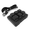 A black 6-key mechanical macro pad and its braided USB cable are shown on a white background. Produktbild-Vorschau