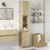 A bathroom scene with a tall cabinet, vanity, sink, mirror, and laundry basket. Náhled obrázku produktu