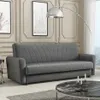 A gray sofa is shown in a living room setting with decorative wall paneling and a floor lamp. Náhľad obrázku produktu