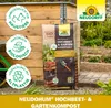 A bag of compost is placed in front of a wooden structure, with garden elements in the background. Produktbild-Vorschau