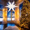 A decorated room with a Christmas tree and a star lantern. Podgląd zdjęcia produktu