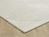 A close-up view of a cream-colored rug with a geometric pattern, placed on a wooden floor. Produktbild-Vorschau