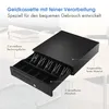 A black cash drawer with its compartments open, placed on a wooden surface. Text overlays describe its features. Podgląd zdjęcia produktu