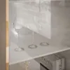 Three wine glasses are displayed on a white shelf, with shadows cast on the wall behind them. Produktbild-Vorschau