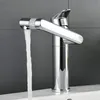 A close-up shot of a chrome faucet with water running into a sink. Podgląd zdjęcia produktu