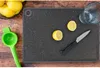 A cutting board with lemons, a knife, and a juicer. Anteprima dell’immagine prodotto