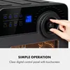 Close-up of an air fryer's digital control panel and a hand interacting with the on/off button. Text overlay describes "SIMPLE OPERATION" and "Clear digital control panel with touchscreen". Náhľad obrázku produktu