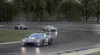 Three racing cars on a wet track during a race. Produktbild-Vorschau