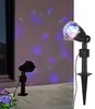 Two LED party lights project colorful dots onto a wall and patio. Produktbild-Vorschau