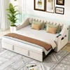 A beige sofa bed with storage drawers and side organizers, set up in a room with decorative pictures on the wall and a potted plant. Náhľad obrázku produktu