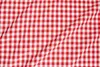 A close-up, flat lay of red and white checkered fabric. Produktbild-Vorschau