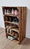 A wooden shoe rack filled with various shoes, placed against a wall on a wooden floor. Náhled obrázku produktu