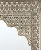 A close-up view of an ornate, gold-colored metal mirror frame with intricate floral and geometric patterns. Náhľad obrázku produktu