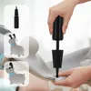 A hand is using a pump to inflate a gray dog-shaped bouncy toy. Inset images show the pump and the toy. Produktbild-Vorschau