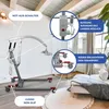 A patient lift is shown in a room with a sofa and a plant. Produktbild-Vorschau