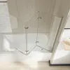 A glass shower enclosure over a bathtub. Produktbild-Vorschau