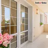 A balcony with glass doors, a wall lamp, and flowers. Podgląd zdjęcia produktu