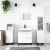 A modern white bathroom vanity set with a sink, cabinet, and storage tower against a white tiled wall. Produktbild-Vorschau