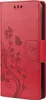 A red flip case for a smartphone with a floral and butterfly embossed design. Produktbild-Vorschau