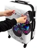Hands peeling protective film off a suitcase. Náhled obrázku produktu
