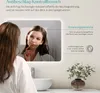 A woman looking into a bathroom mirror with fogging technology. Anteprima dell’immagine prodotto