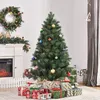 A decorated Christmas tree with presents underneath, next to a fireplace and a wreath. Produktbild-Vorschau