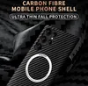 A close-up of a black carbon fiber phone case with a MagSafe ring, set against a dark, textured background. Náhled obrázku produktu