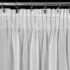 A close-up view of a white sheer curtain hanging from a metal rod. Produktbild-Vorschau