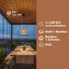 A dining table set up on a balcony with a hanging lamp above. Produktbild-Vorschau