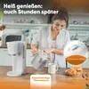 A woman is pouring coffee from a thermal carafe into a mug next to a coffee maker. Anteprima dell’immagine prodotto