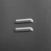A close-up view of two small, raised rectangular indentations on a dark gray textured surface. Náhled obrázku produktu