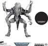 A grey action figure of a creature with multiple arms and a tentacled head, standing on a white background. A black circular base with the Warhammer 40,000 logo is to the right of the figure. Náhled obrázku produktu