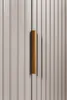 A close-up view of a cabinet door with a gold handle. Náhled obrázku produktu