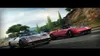 Two sports cars racing on a winding road. Produktbild-Vorschau