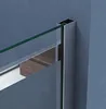 Close-up view of a shower enclosure corner, showing the glass, metal frame, and a wooden cabinet in the background. Produktbild-Vorschau