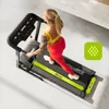 A woman is running on a treadmill in a home gym setting. Produktbild-Vorschau