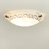 A close-up, straight-on shot of a ceiling light fixture mounted on a white ceiling. Produktbild-Vorschau