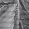A close-up view of a gray striped duvet cover and pillowcase. Produktbild-Vorschau