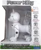 A white robot cat toy is displayed inside its retail packaging. The packaging is mostly white with some gray and green accents, and features text and icons describing the toy's features. A remote control is also visible, secured to the packaging with a rub Anteprima dell’immagine prodotto